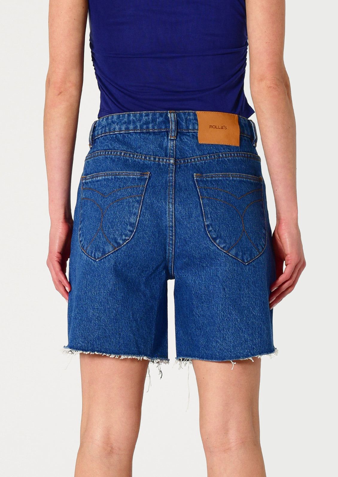 Blue denim shorts with a brand label on a white background