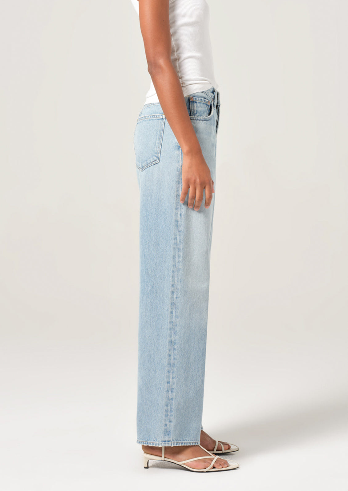 A person wearing a pair of light wash denim jeans with slightly tapered ankle.