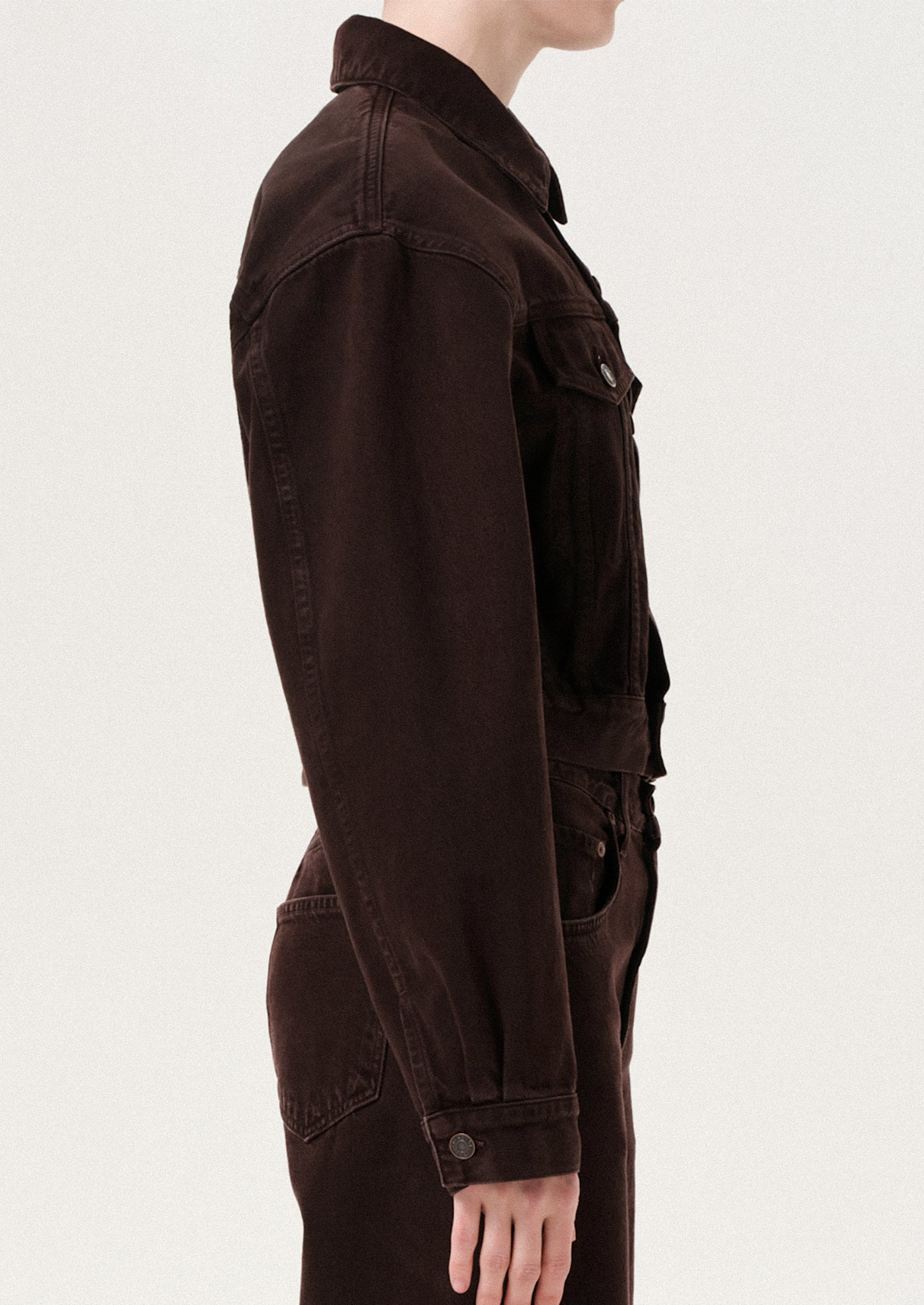 Brown jacket worn by a person on a white background