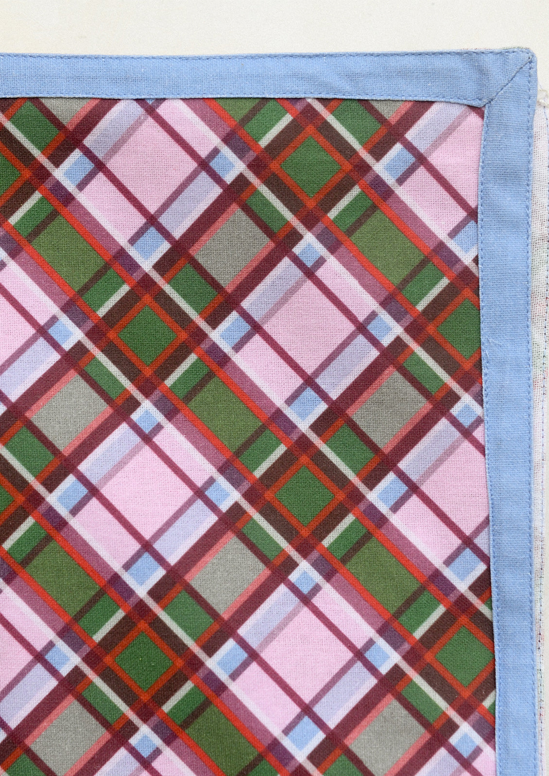 Plaid patterned fabric with a blue border