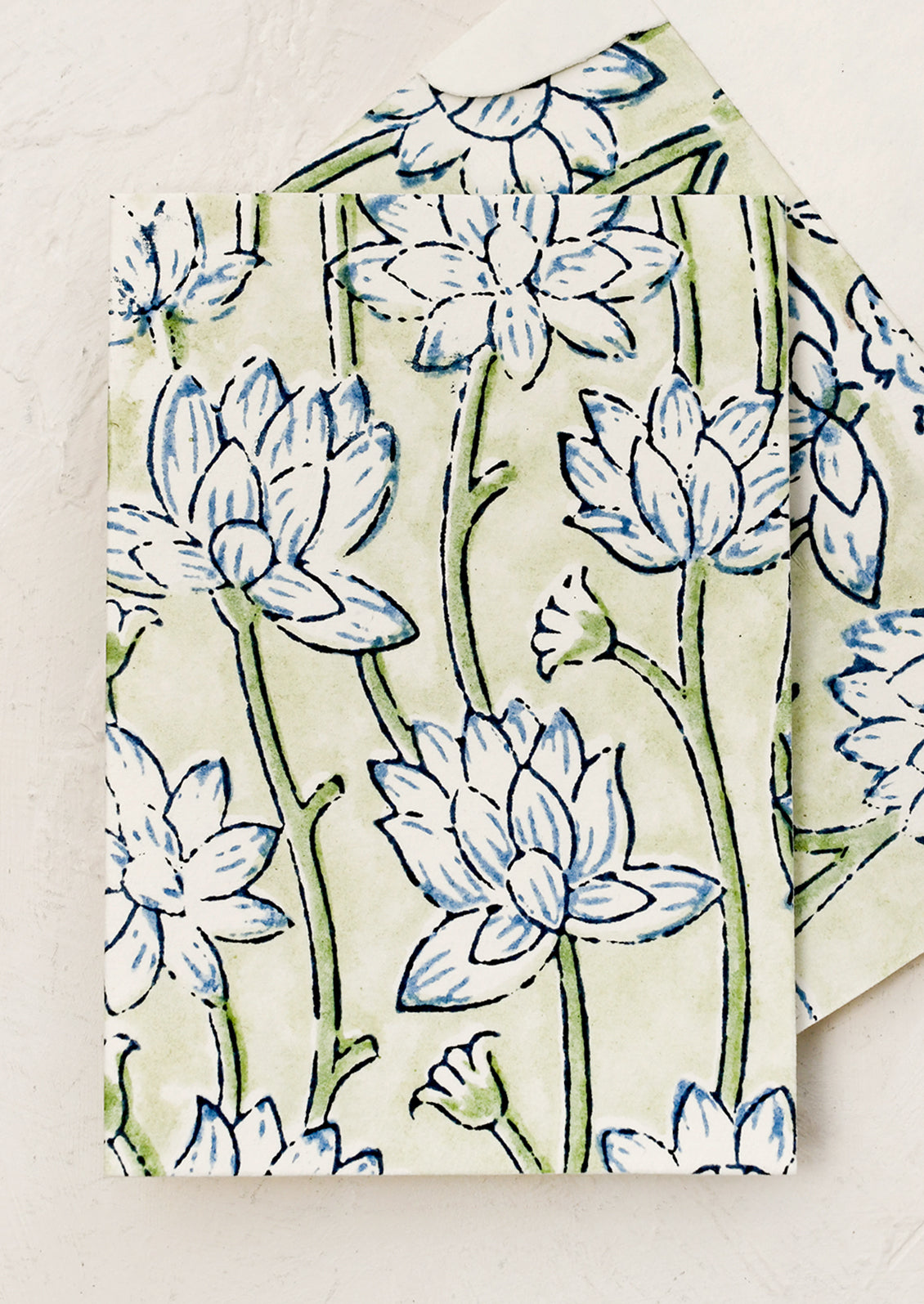 A block printed floral card with matching lined envelope in green and blue colorway.