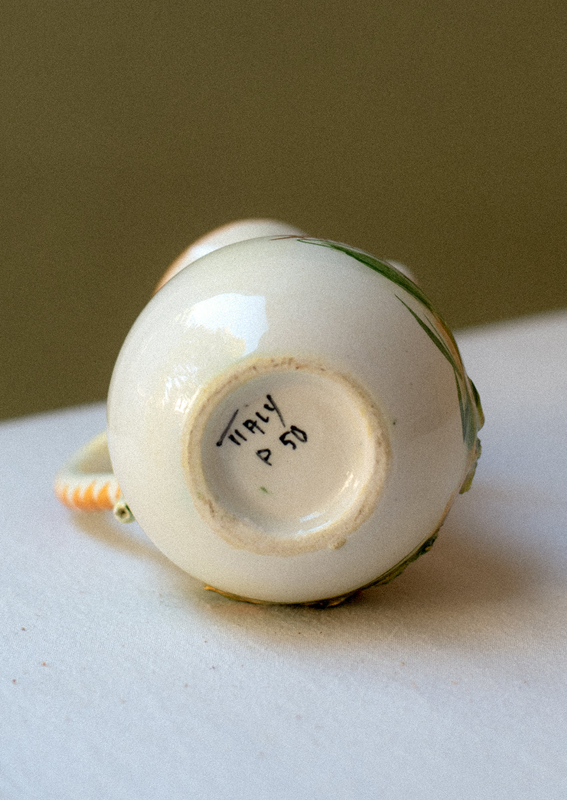 Vintage hand-painted porcelain mini pitcher / creamer with three-dimensional relief detail.