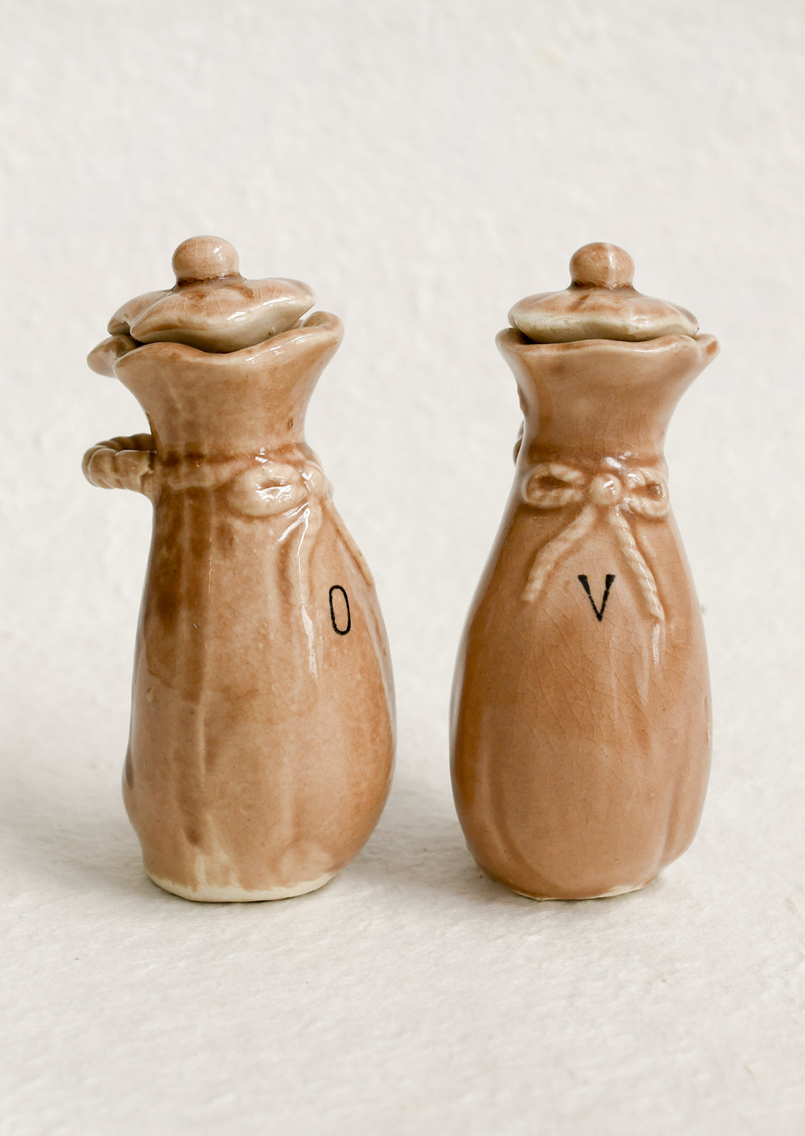 A pair of ceramic oil & vinegar cruets in the shape of bushel baskets.