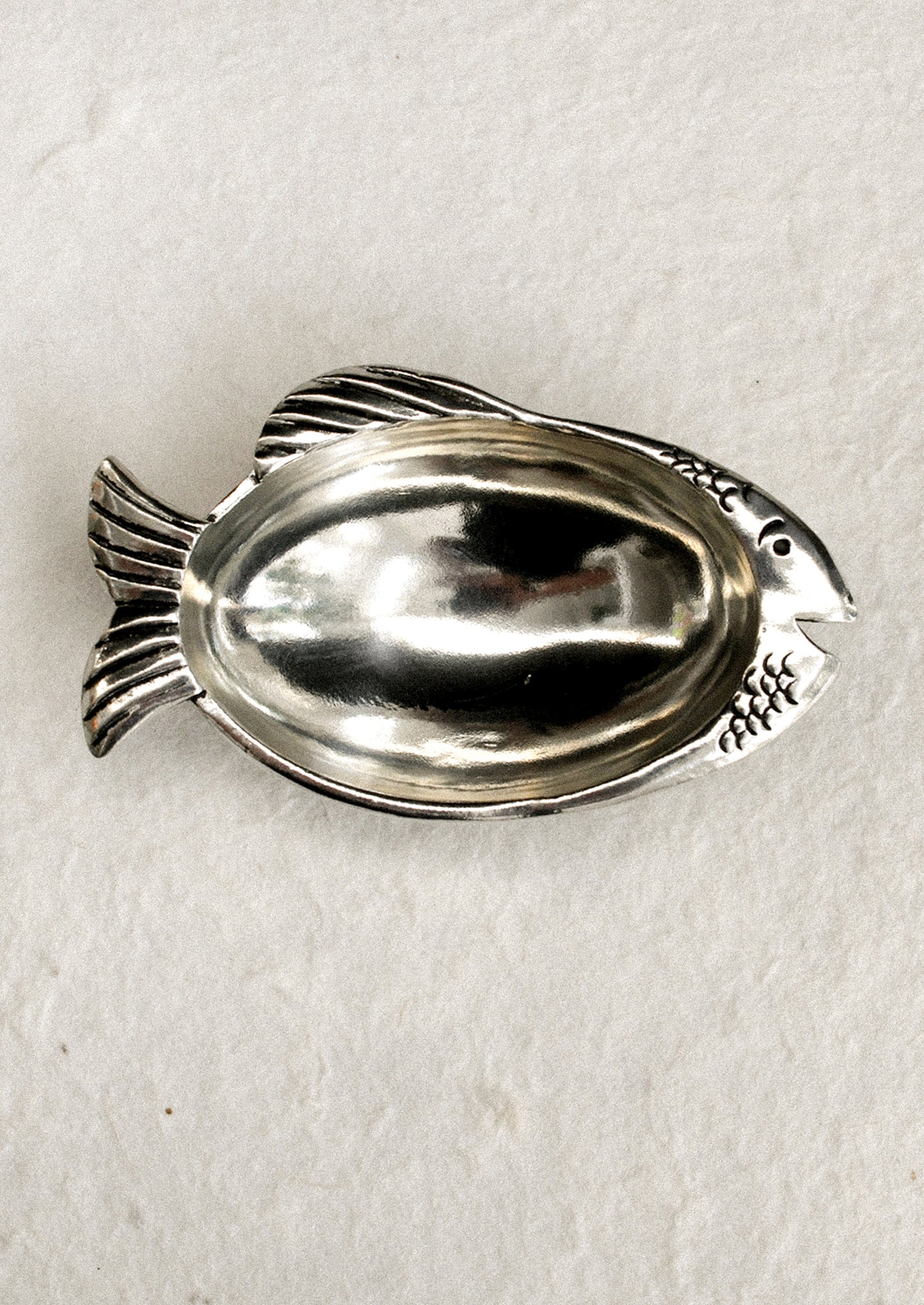 A silver fish shaped dish.