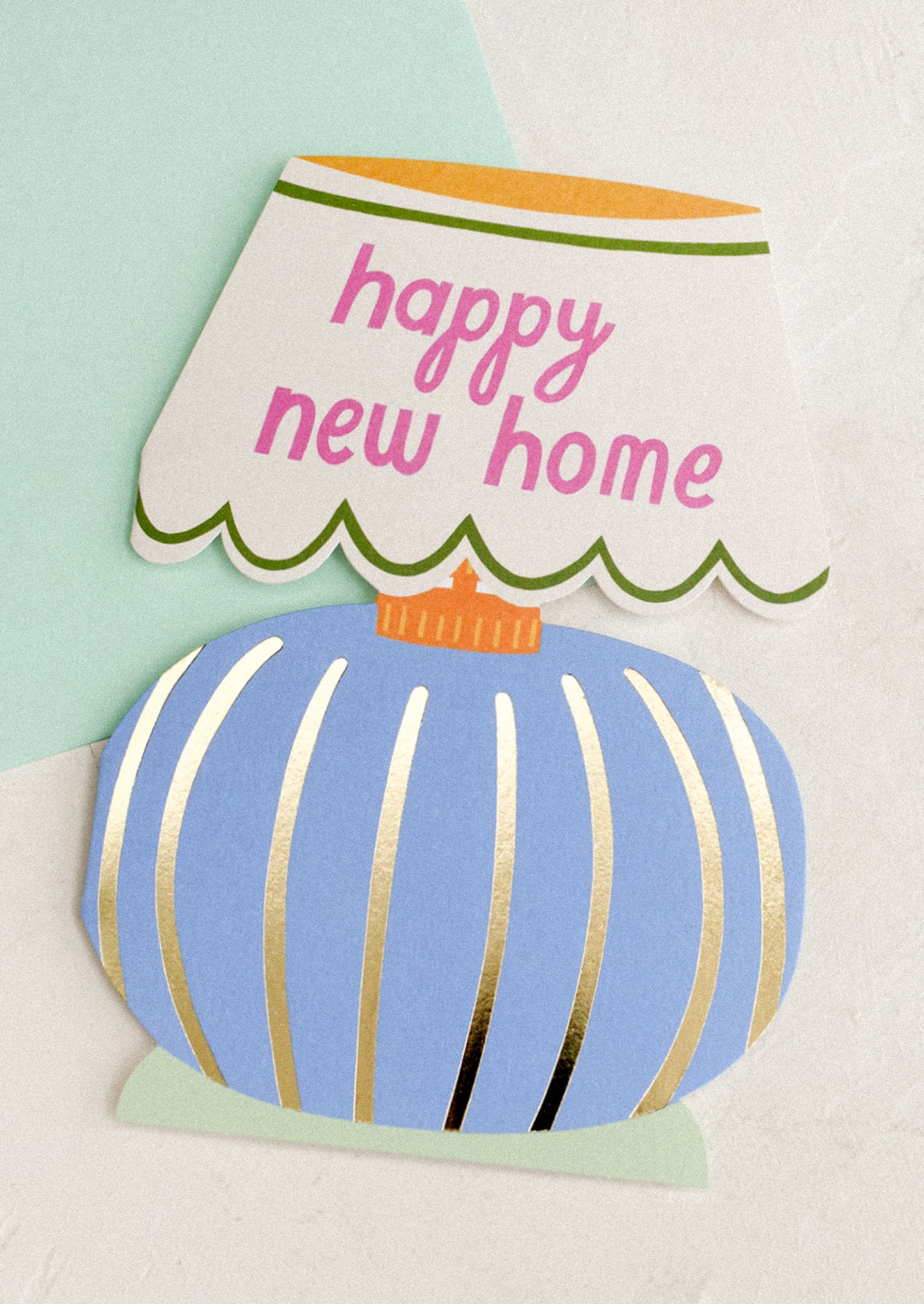 Card with a blue lamp shaped design and 'happy new home' text on a light green background