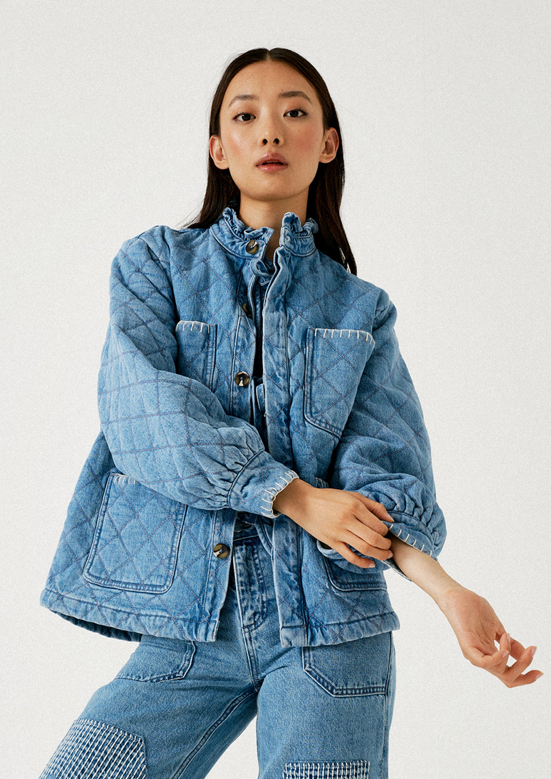 A woman wearing a quilted denim chore coat.