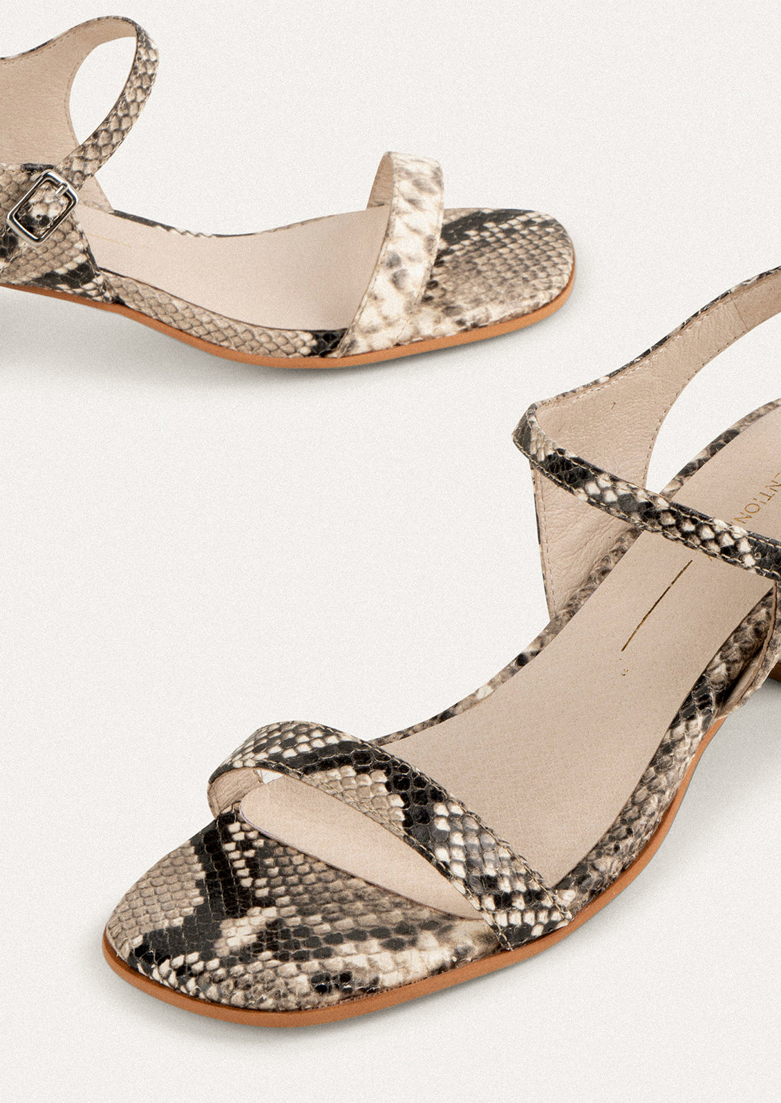A pair of heeled leather sandals in snakeskin.