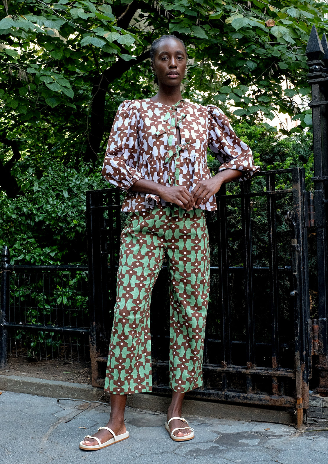 A person wearing a puff sleeve shirt with contrast tie front.