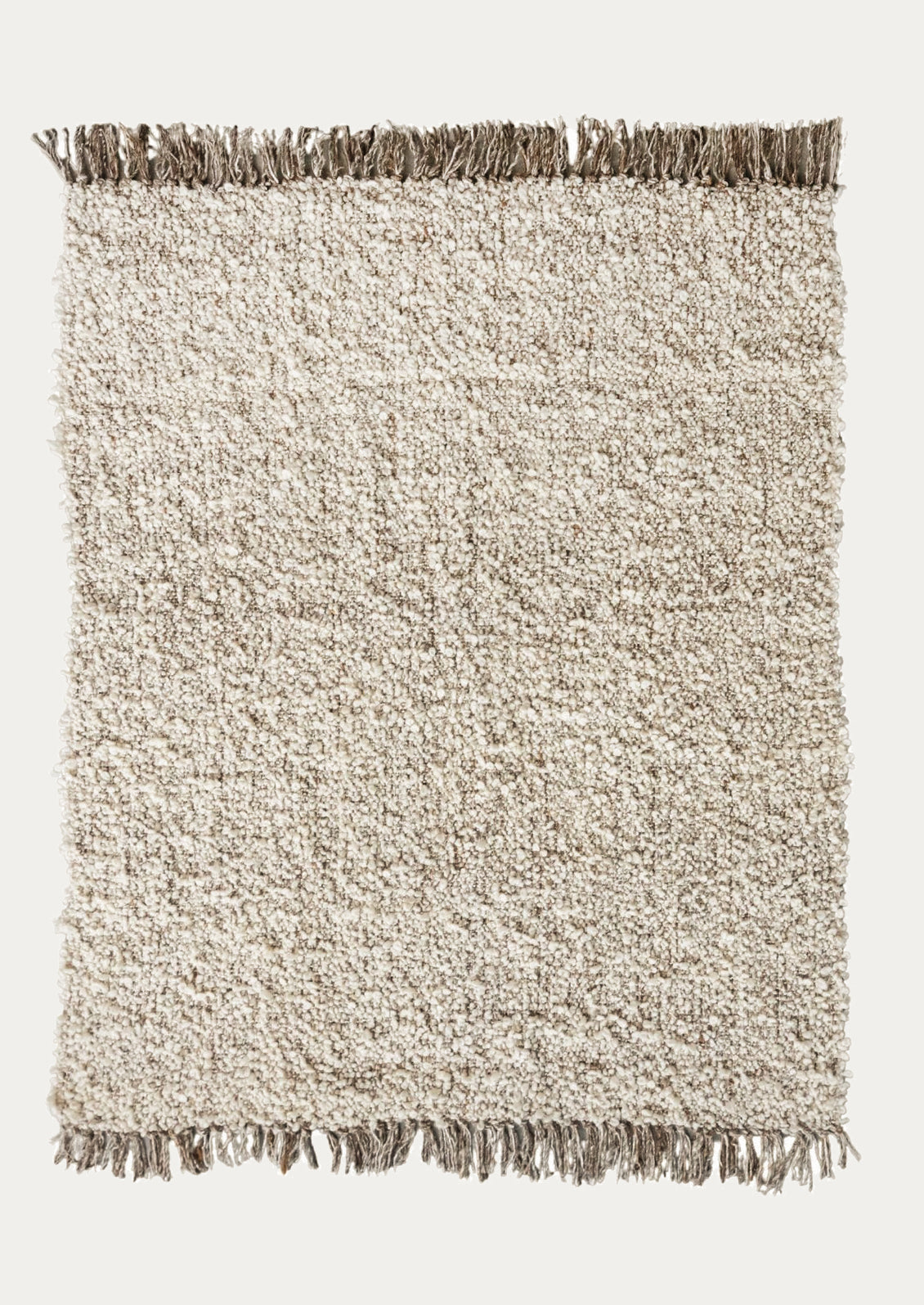 Beige textured rug with brown fringe on a white background