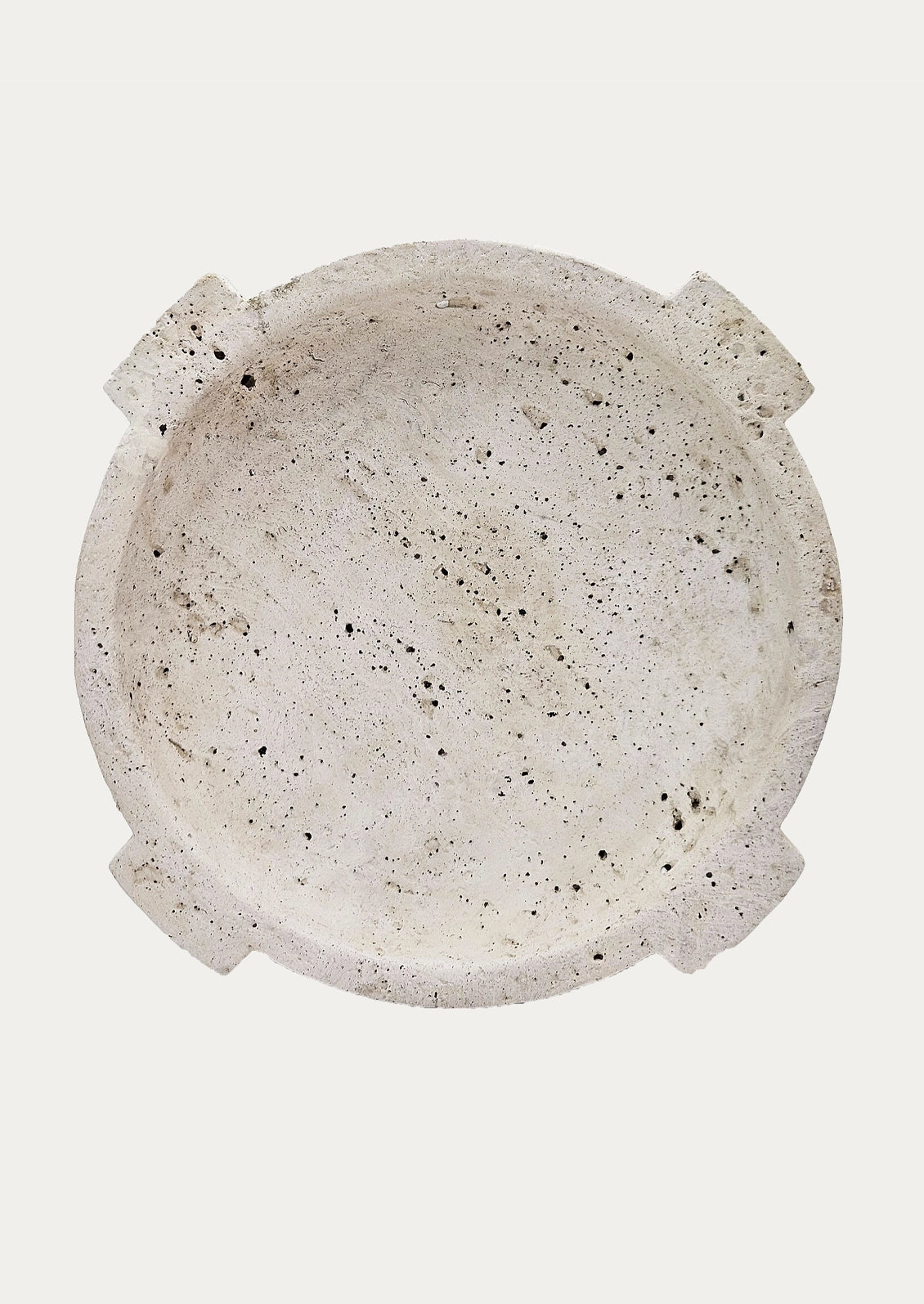 A round travertine decorative bowl.