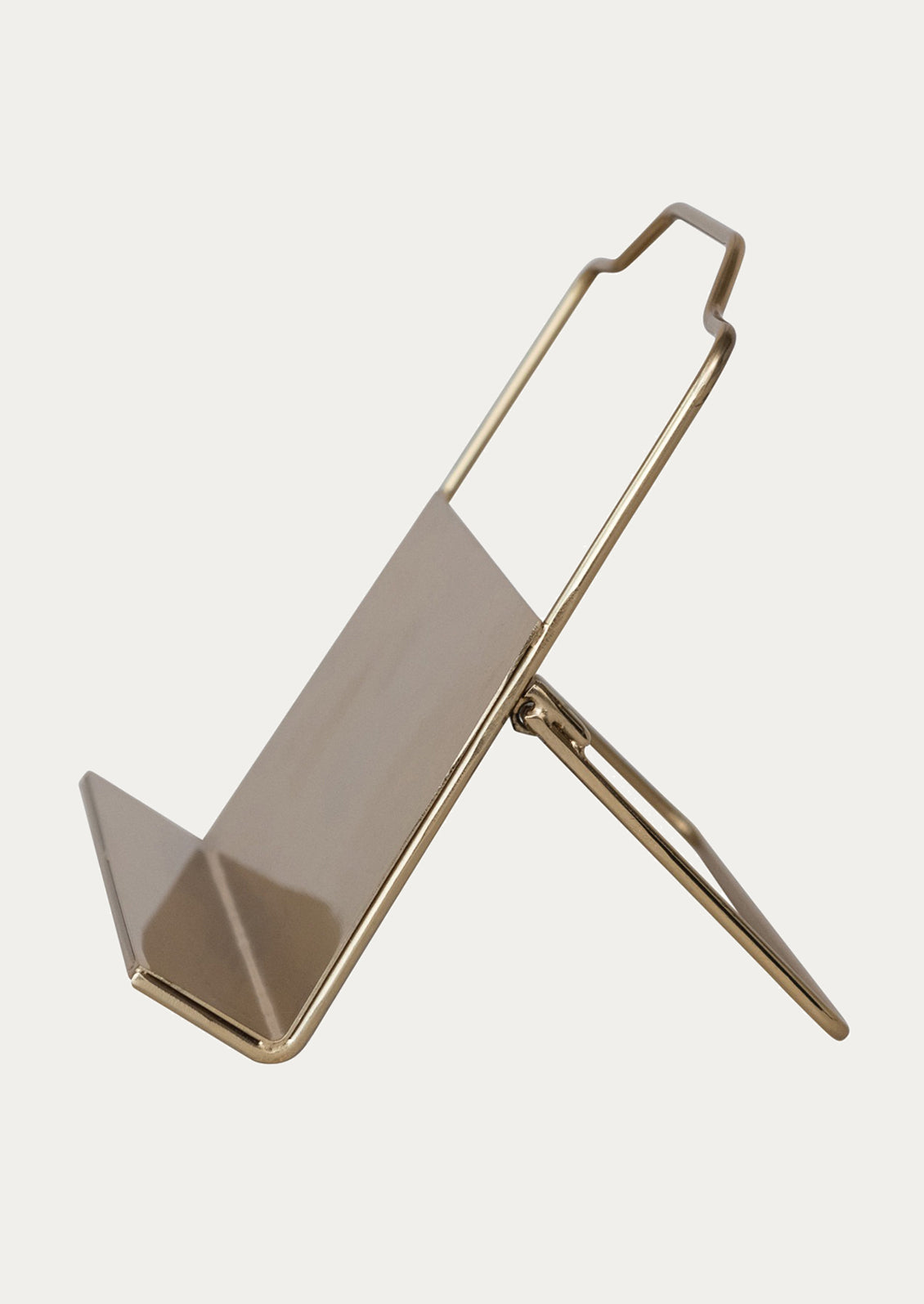 A folding book stand in gold-tone metal.