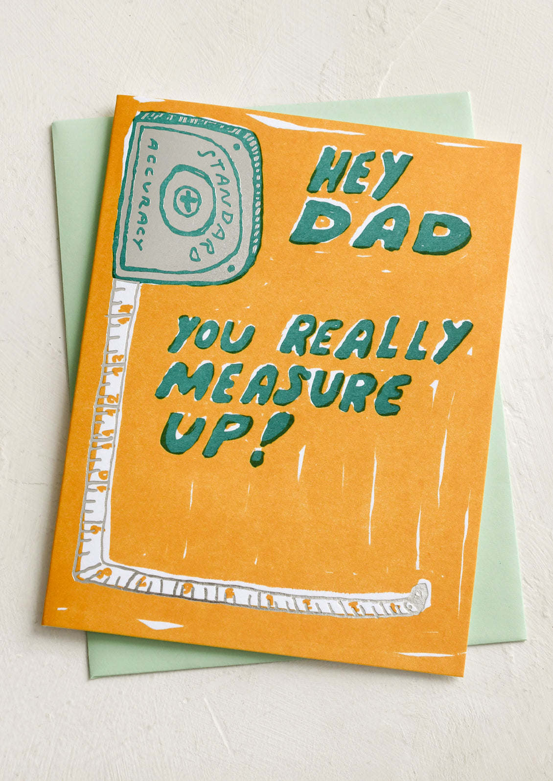 A card with image of tape measure, text reads "Hey Dad, you really measure up!".
