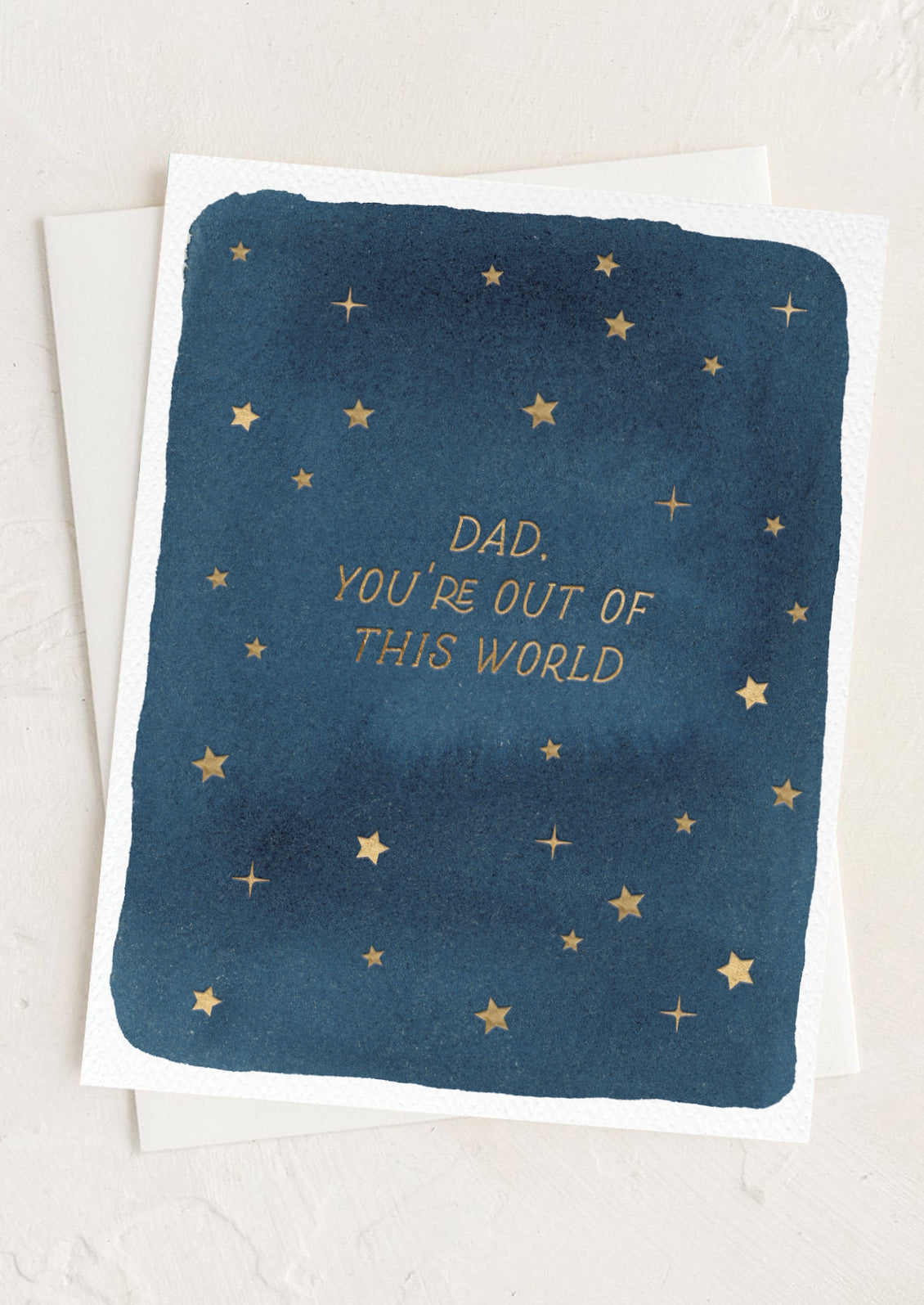 Greeting card with star pattern and text 'Dad, you're out of this world' on a blue background.