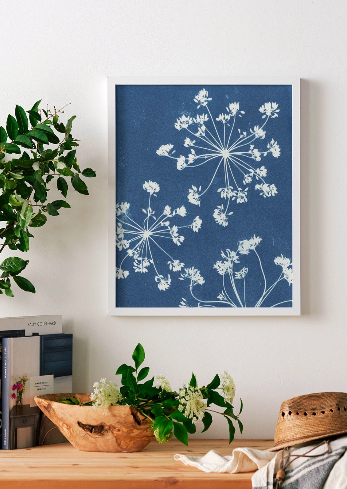 A cyanotype art print with blue background and white silhouette of dill flowers.