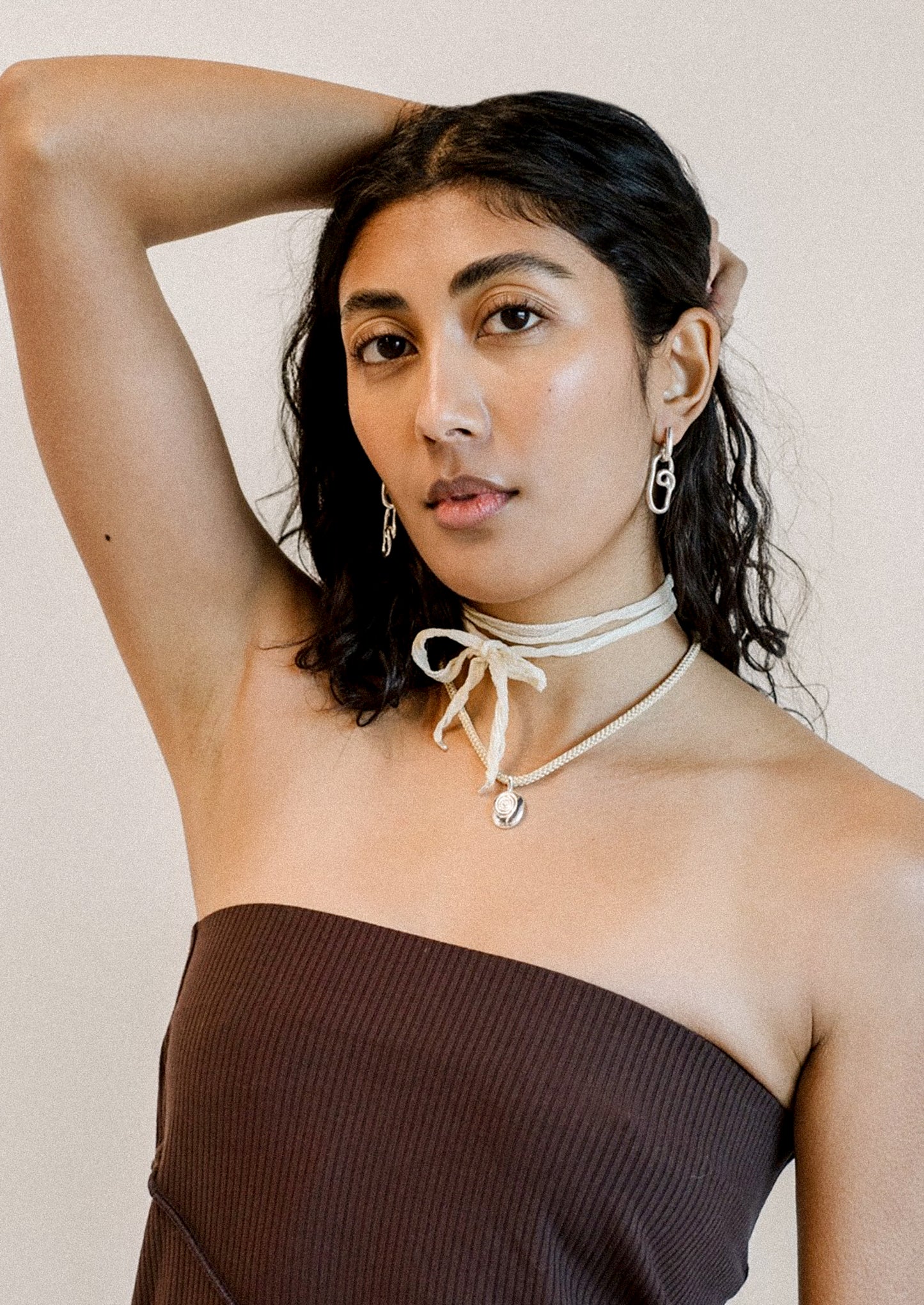 A pair of twisty sterling silver loop shaped earrings.