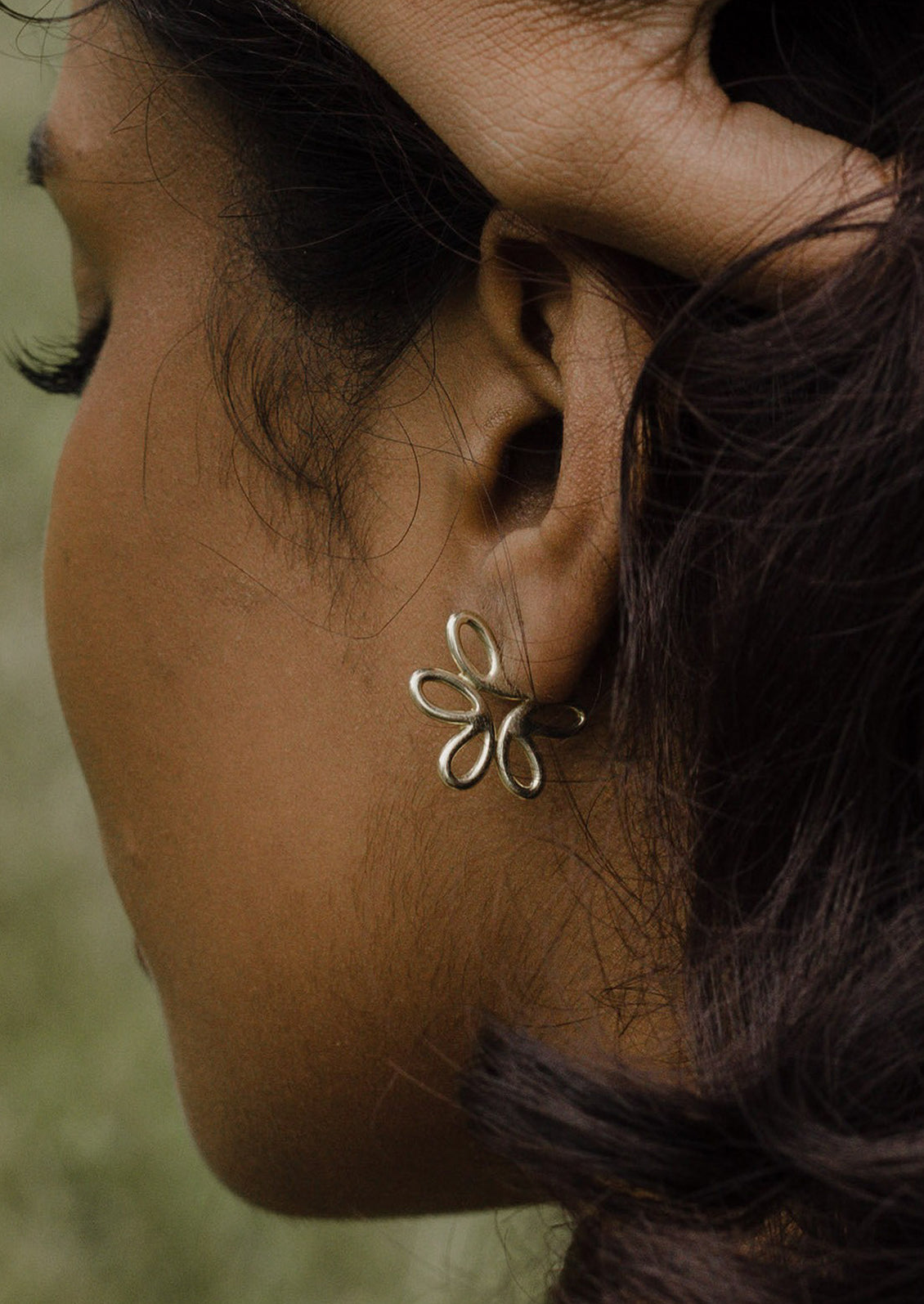 A pair of flower shaped earrings in sterling silver.