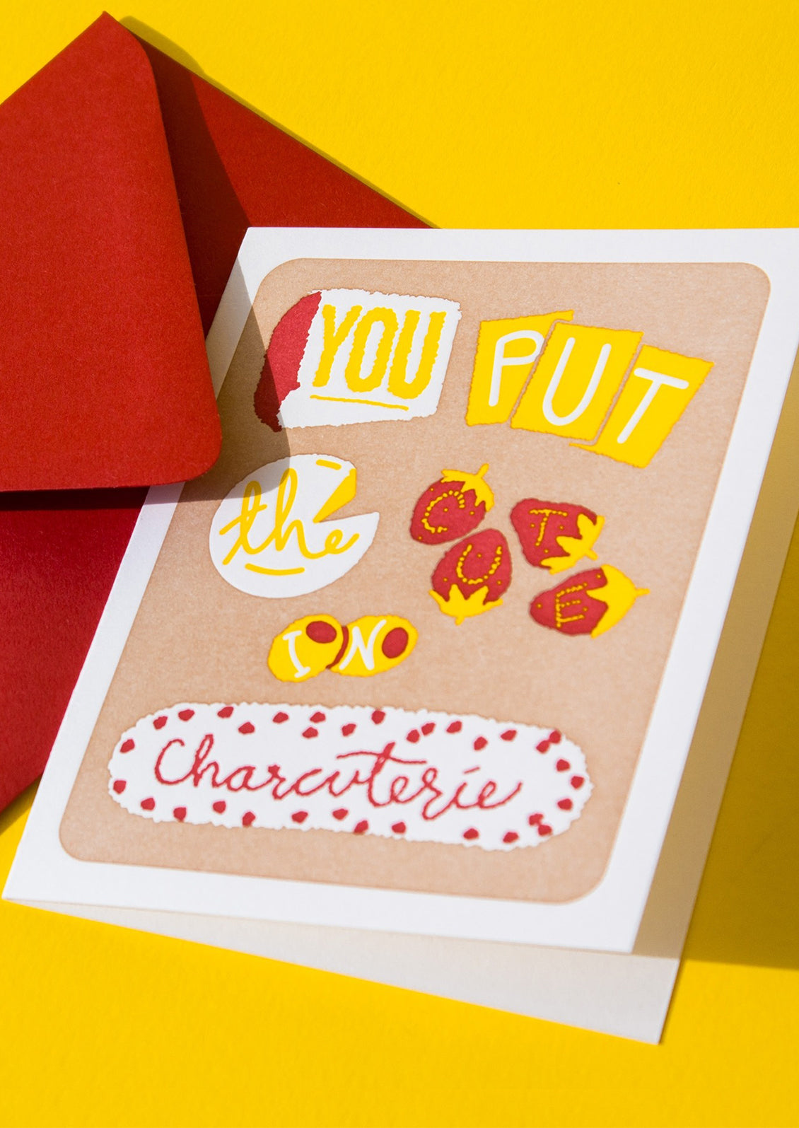 A greeting card with fruit and cheese spelling out "You put the cute in charcuterie".