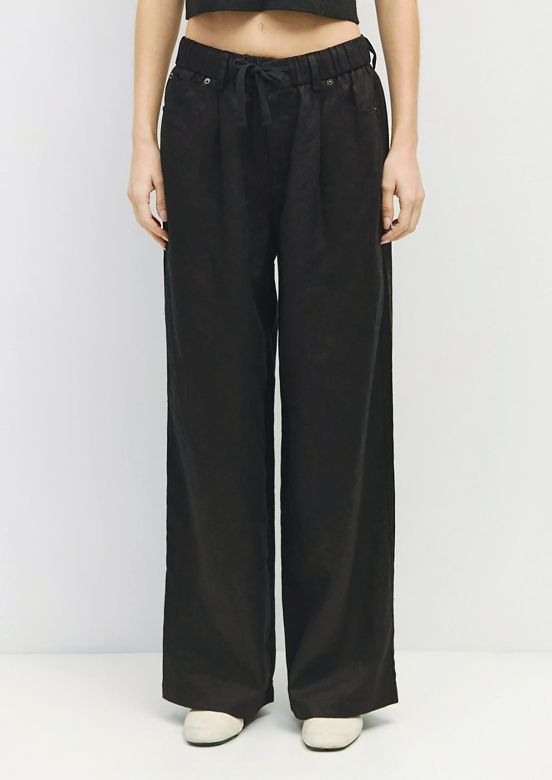 A pair of black linen pants with utility look.