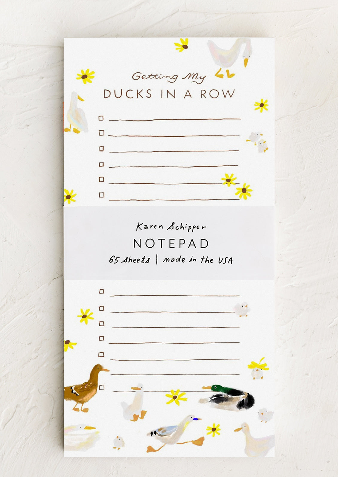 A long notepad with ruled lines and checkboxes, allover duck and flower print.