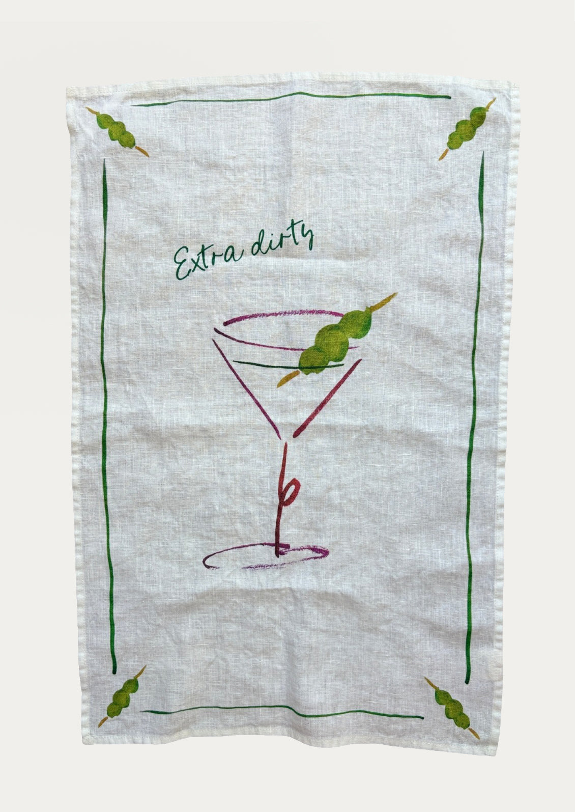 A white linen tea towel with image of martini glass with olive, text reads "Extra dirty".