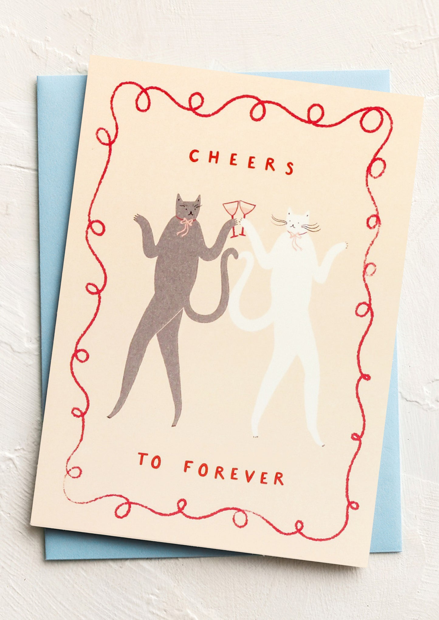 Greeting card with cats and 'Cheers to Forever' text on a light background