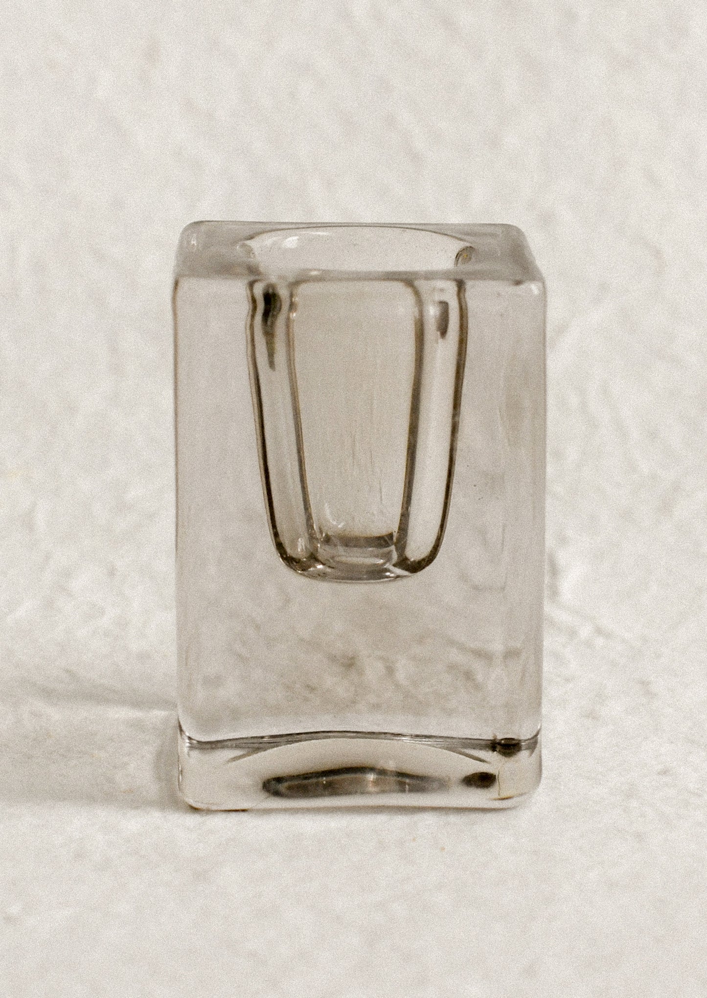 A cube-shaped slab glass candleholder in grey / tall.