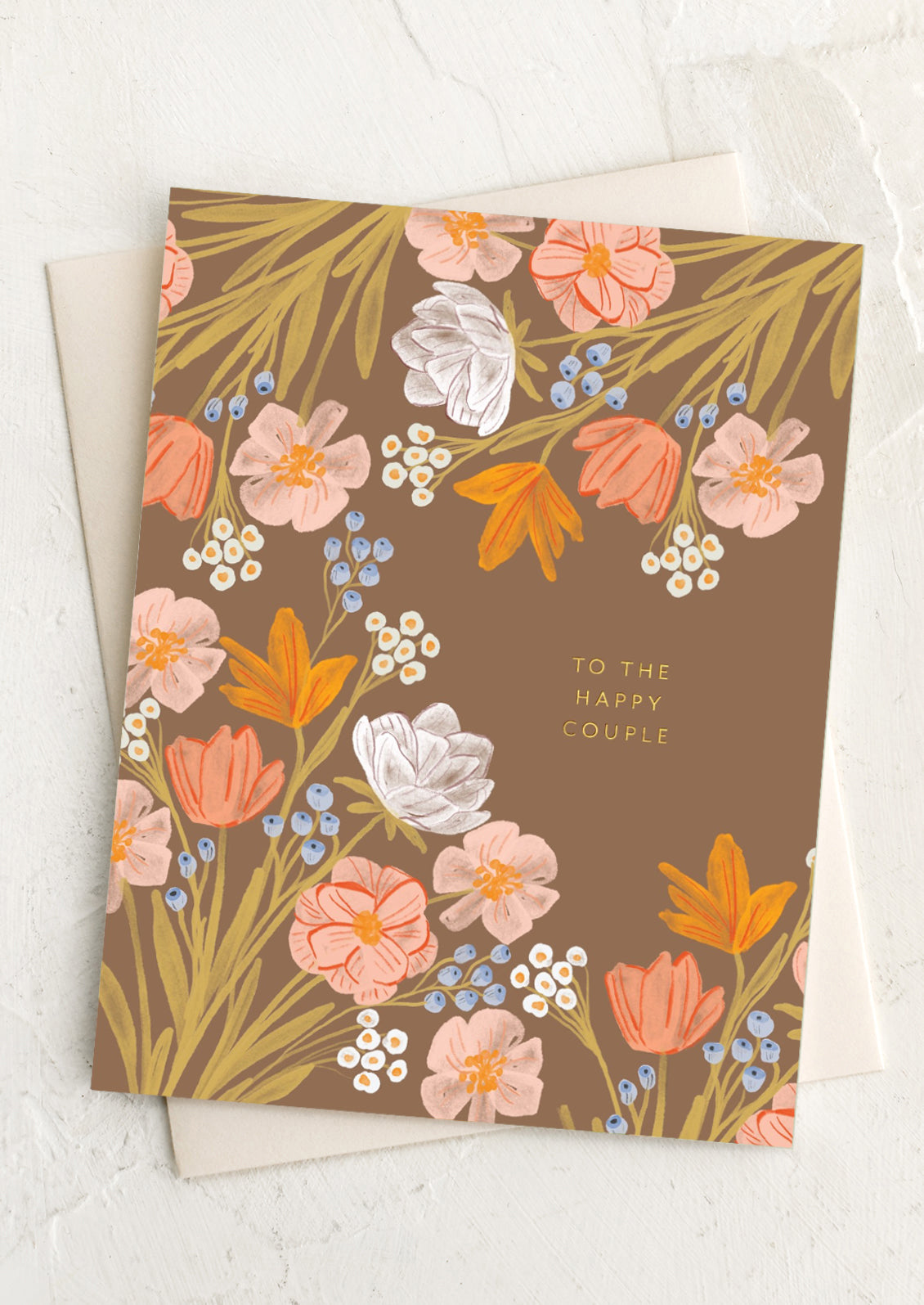 A brown floral print card reading "to the happy couple".