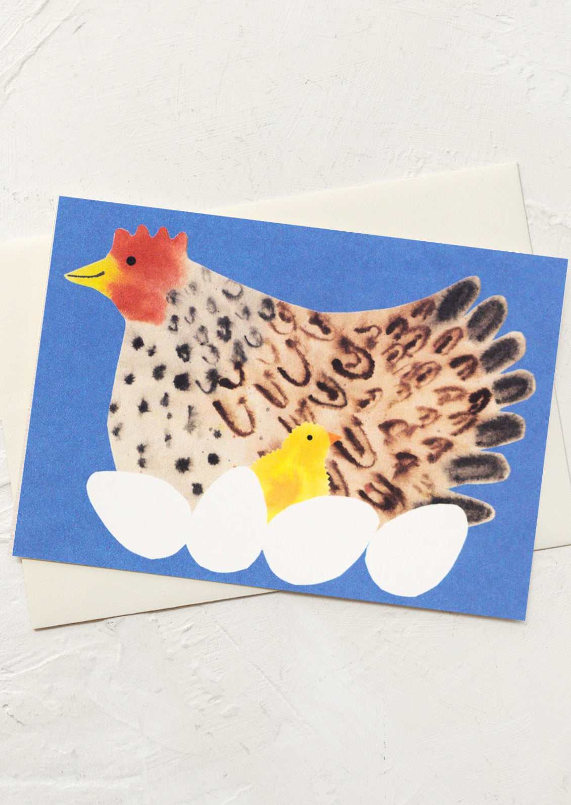Card with a handprint chicken and footprints on eggs against a blue background