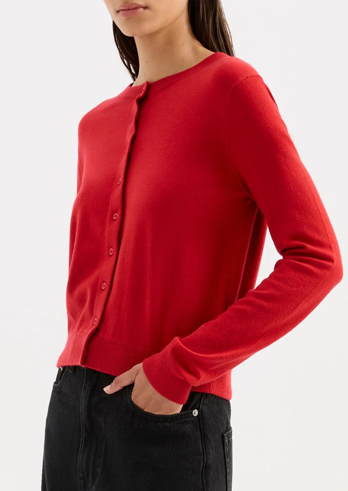 Red long-sleeve shirt worn by a person on a white background