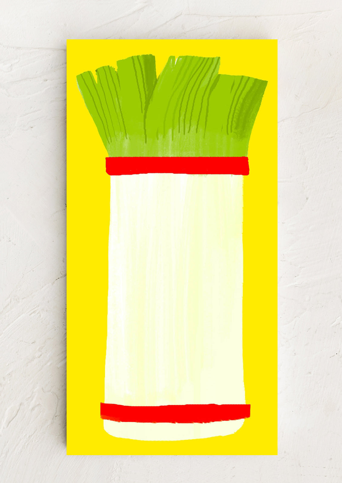 Illustration of a leek with green top and white bulb on a yellow background