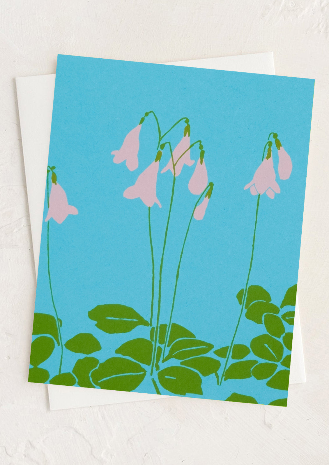 Card with pink flowers and green leaves on a blue background