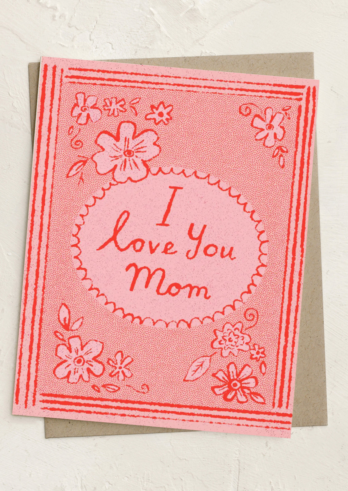 Greeting card with 'I love you Mom' text on a pink background with floral designs.