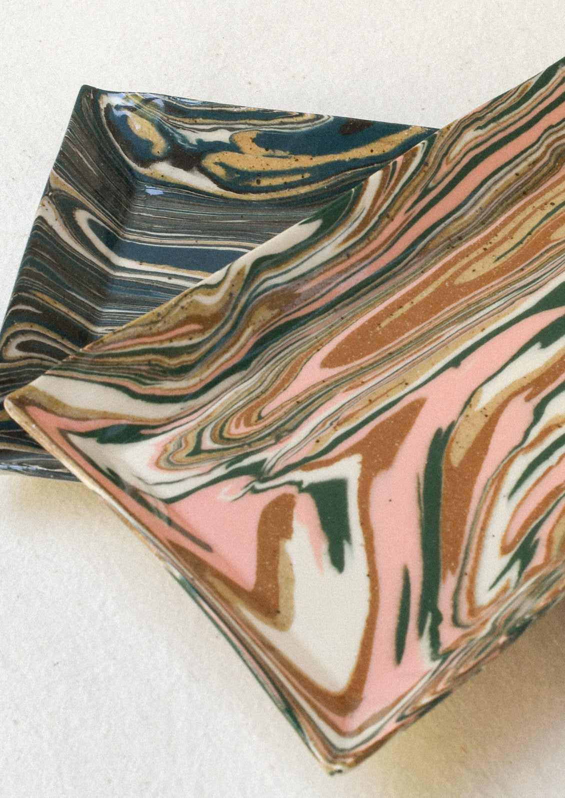 Handmade rectangular catchall trays with a marble design.