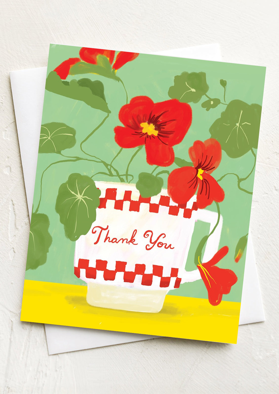 A greeting card with illustration of red nasturtium flowers in a mug, text reads "Thank you".