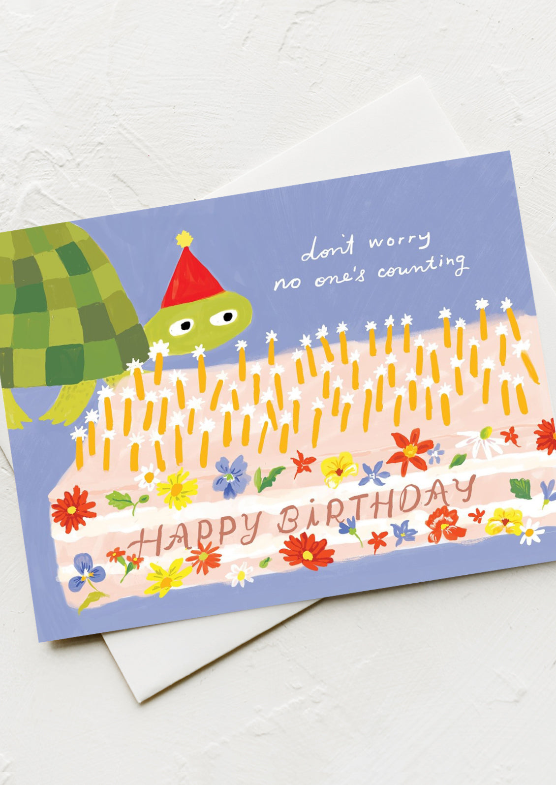 A card with illustration of turtle and birthday cake, text reads "Don't worry, No one's counting. Happy Birthday".