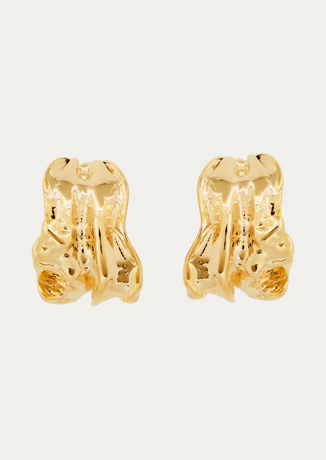 A pair of gold carved cuff earrings.