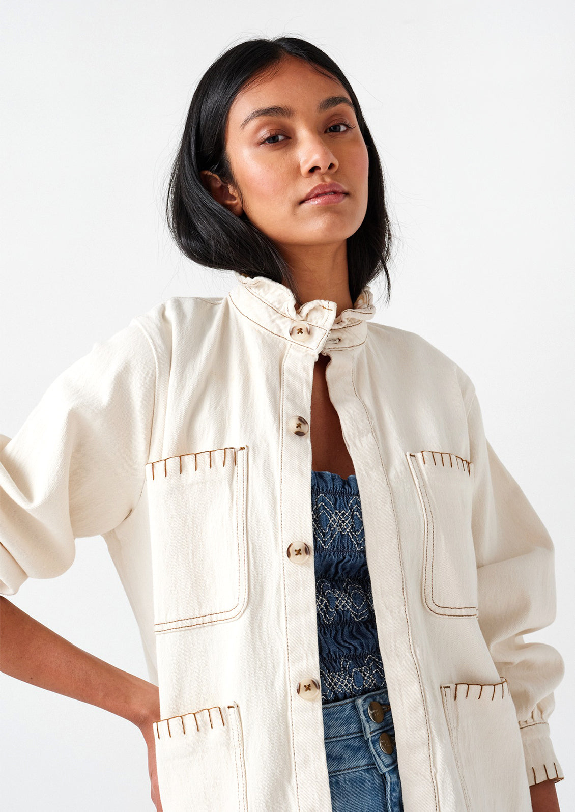 Woman wearing white cotton jacket.