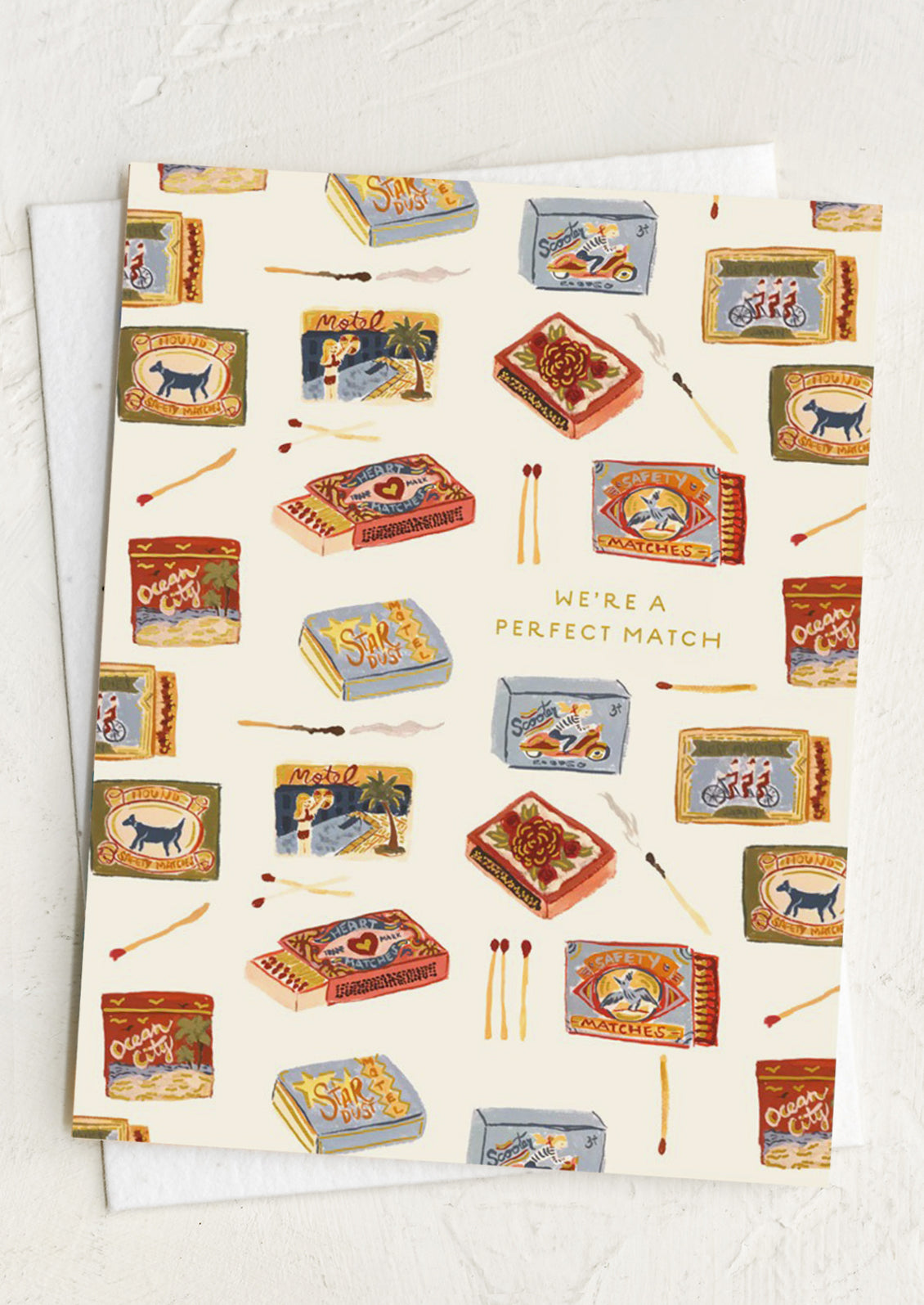 A greeting card with matchbox design and 'We're a Perfect Match' text.