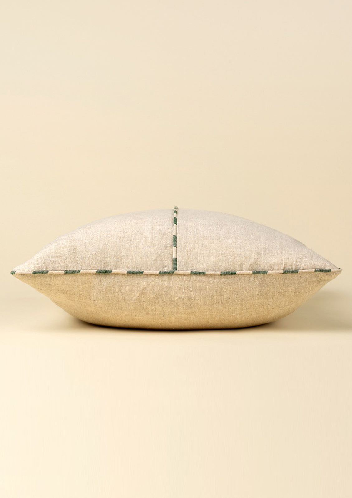 Decorative pillow with a textured pattern on a beige background