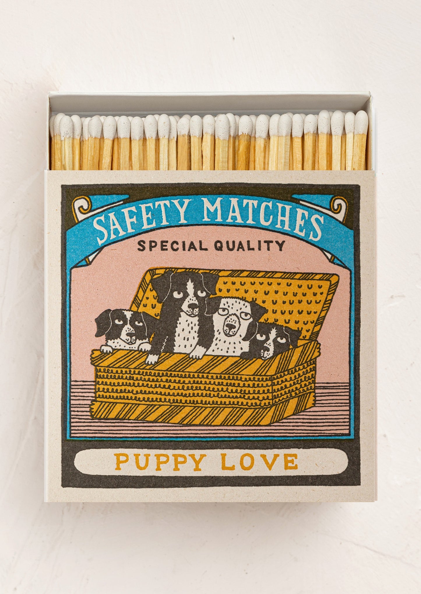 Matches box with illustration of dogs in a basket and 'Puppy Love' text.