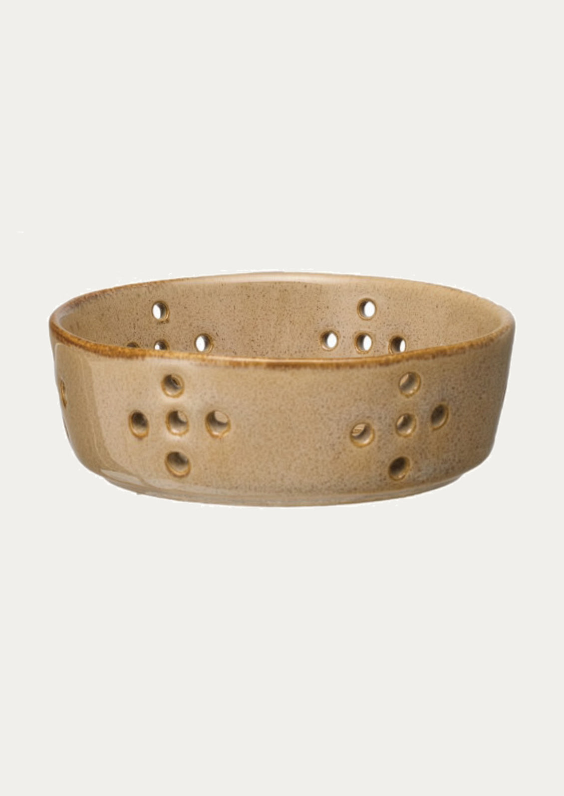 Beige ceramic basket with holes on a white background
