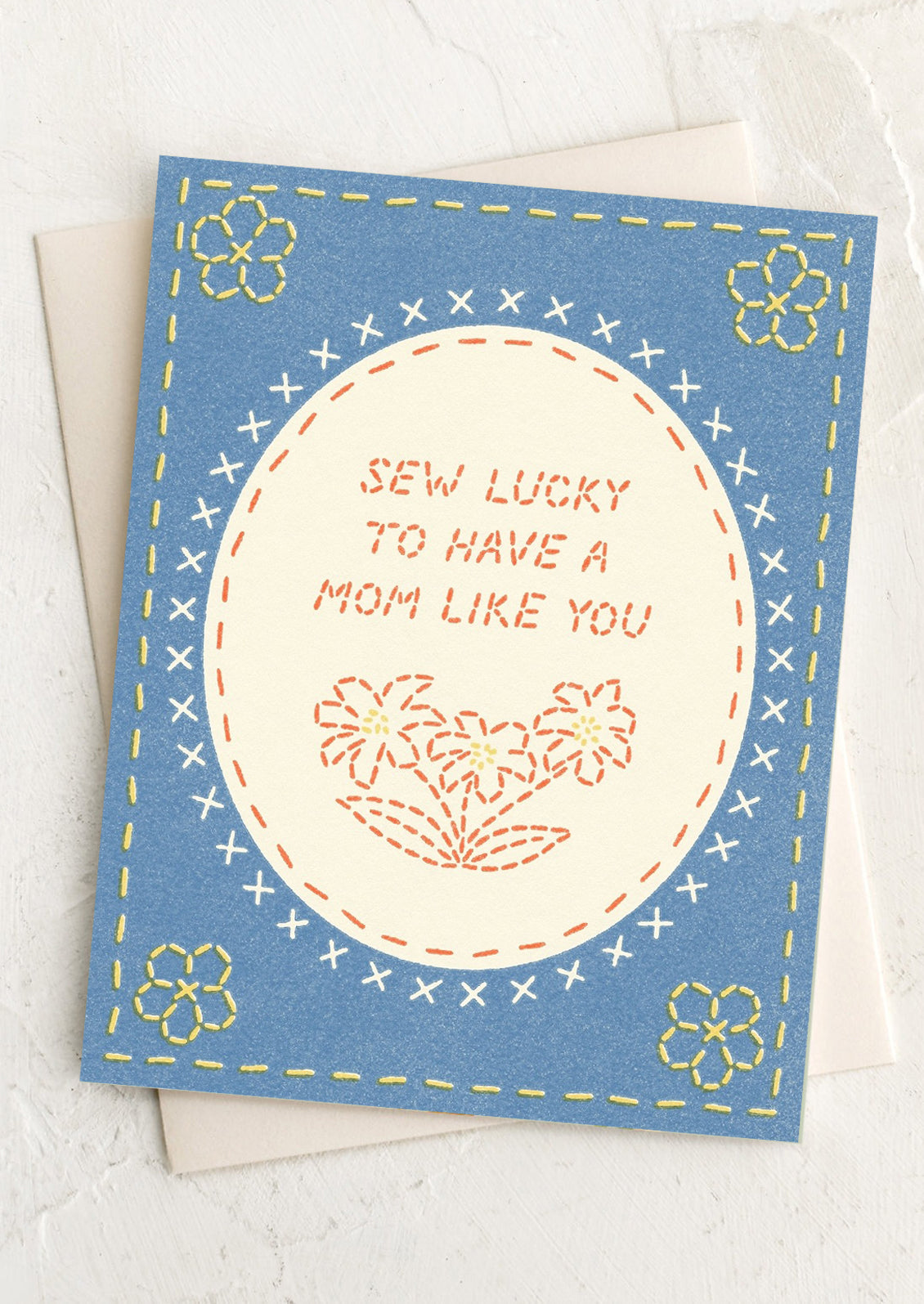 Greeting card with embroidered design and text on a white background