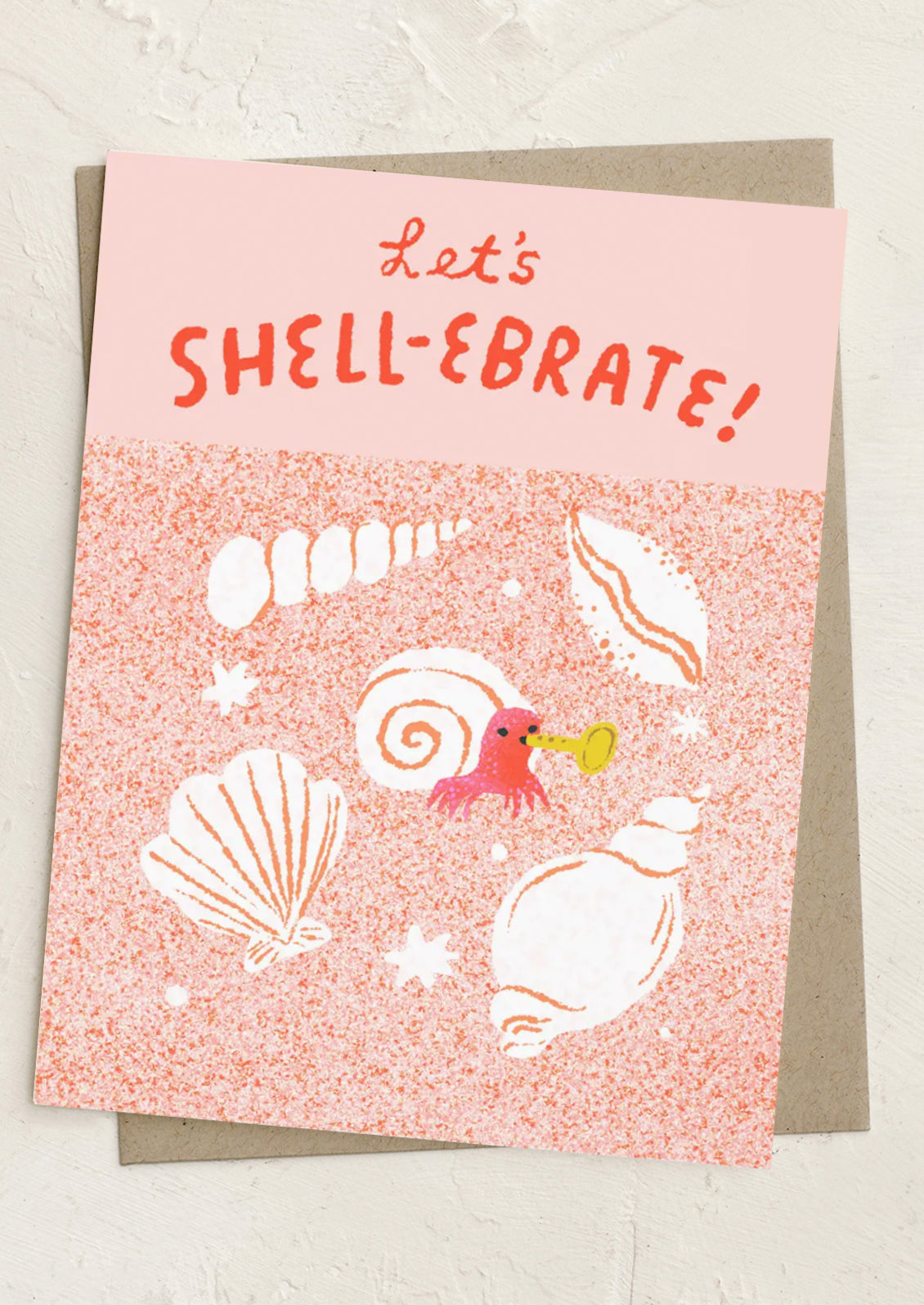 Greeting card with shell illustrations and 'Let's SHELL-EBRATE!' text on a pink background.