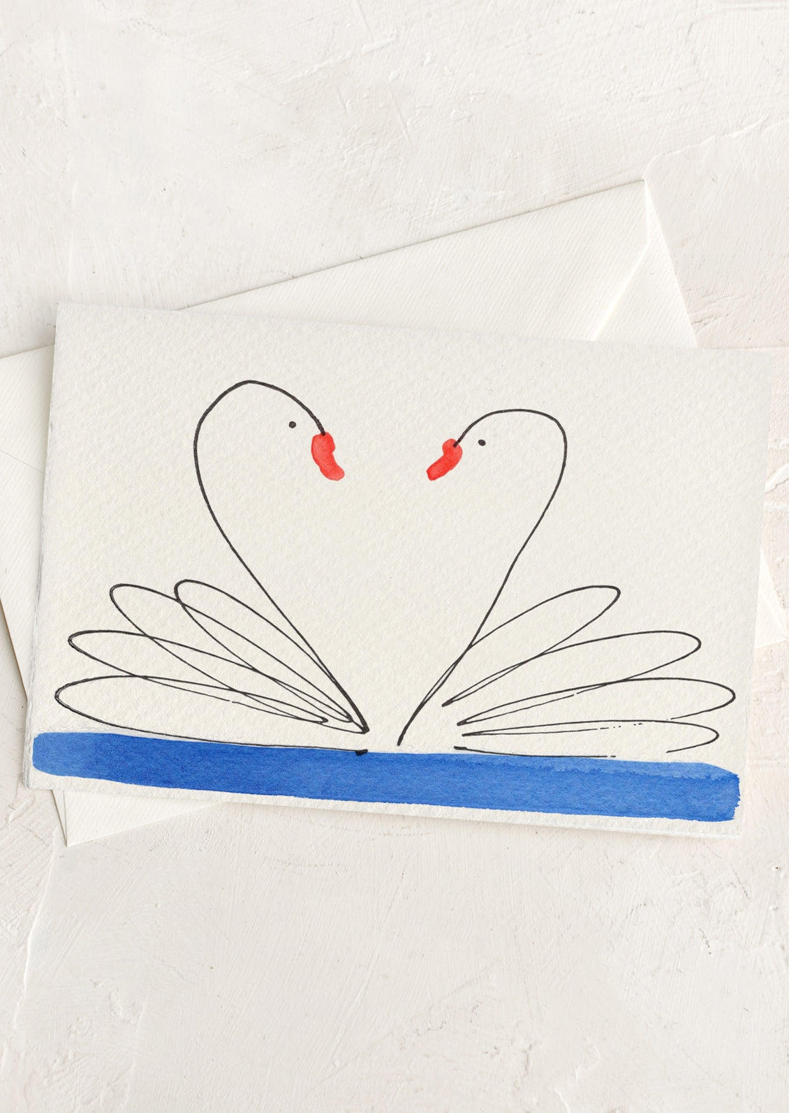Card with two swans forming a heart shape on a white background