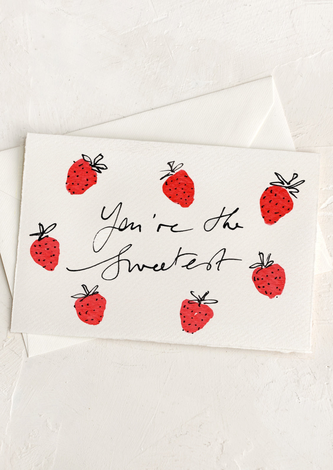 A hand painted card with strawberries, text reads "You're The Sweetest".