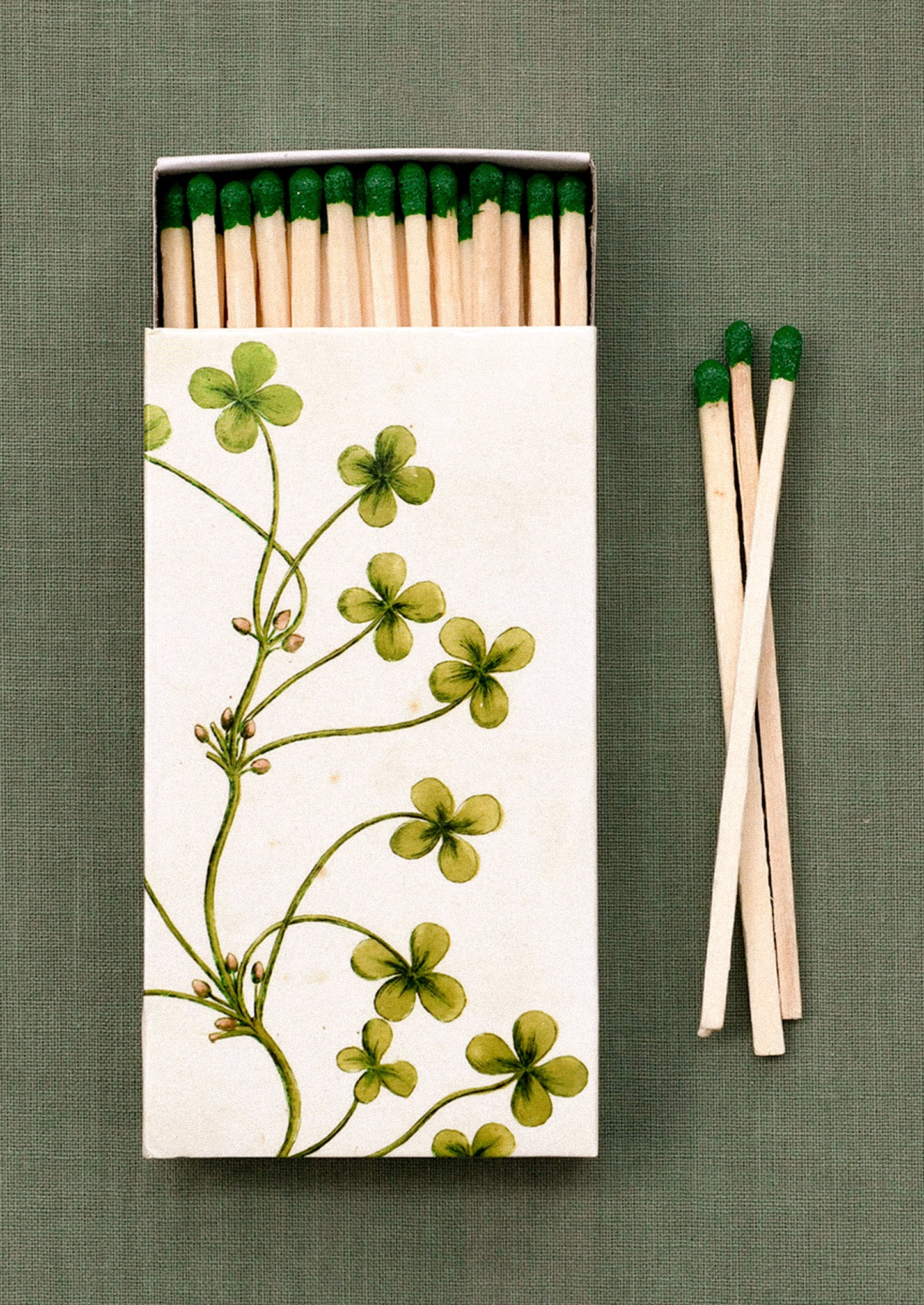 Matches with a floral design on the box against a green background