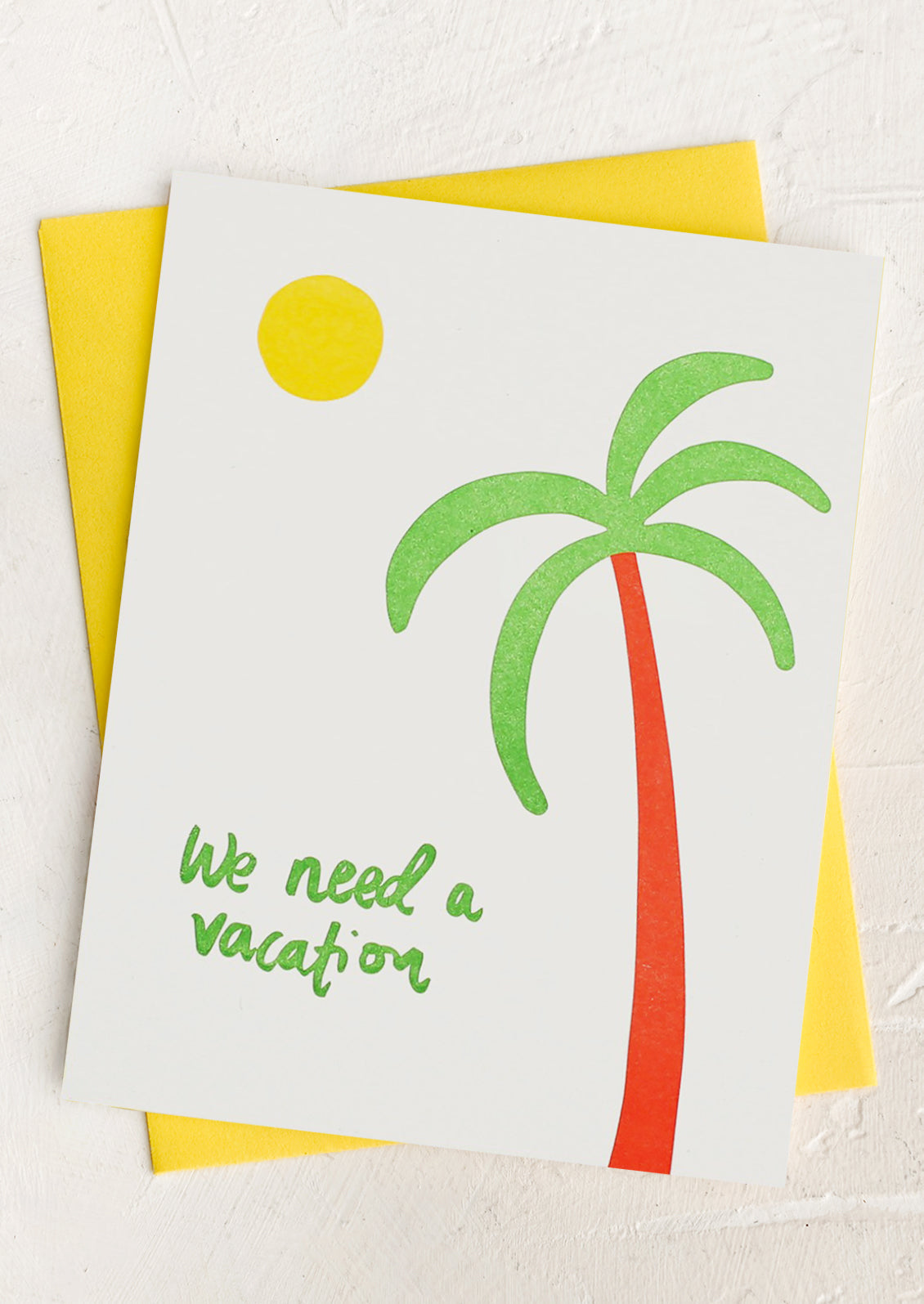 A palm tree print card with text reading "We need a vacation"