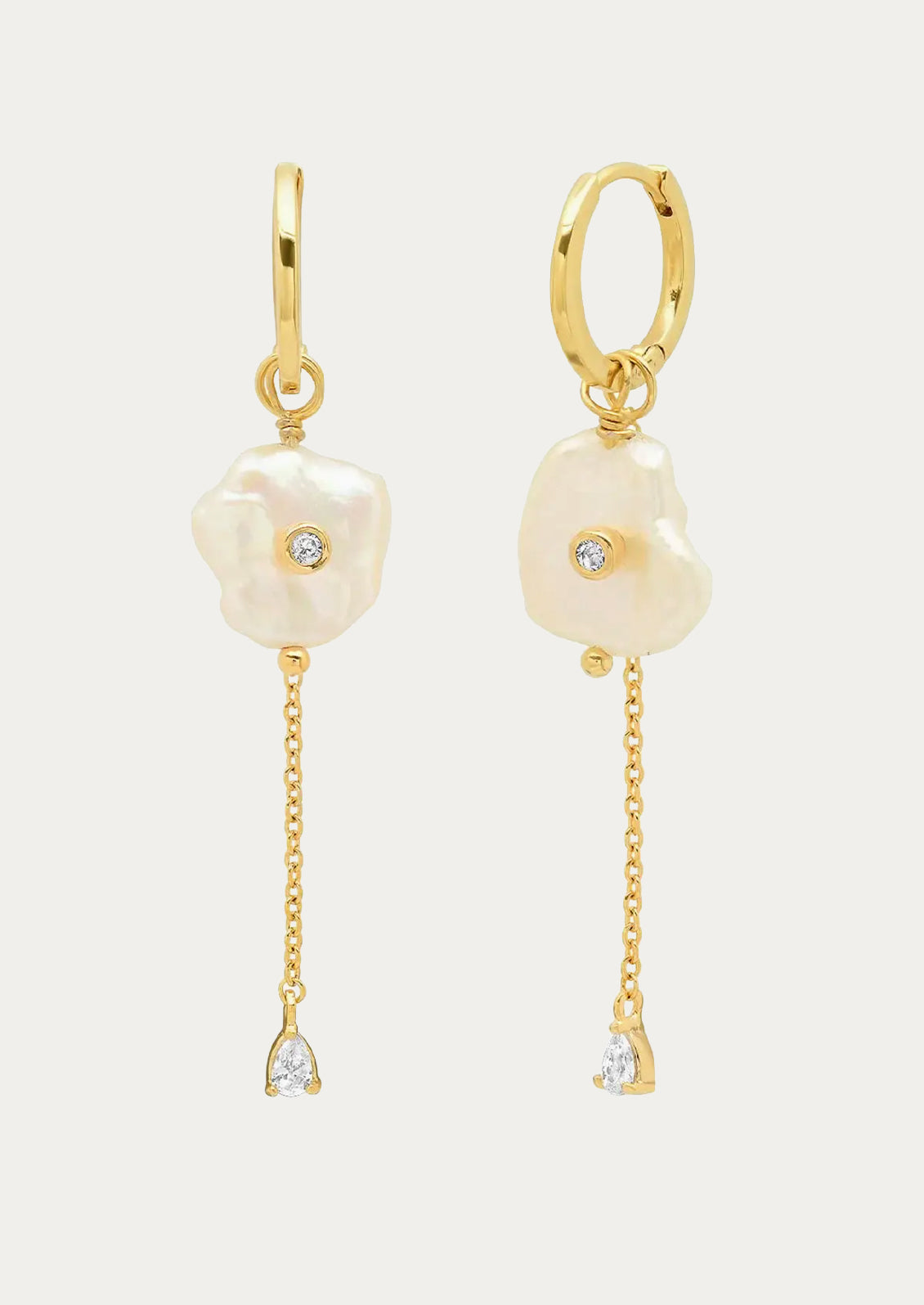 A pair of gold hoop earrings with dangling pearls and chain.