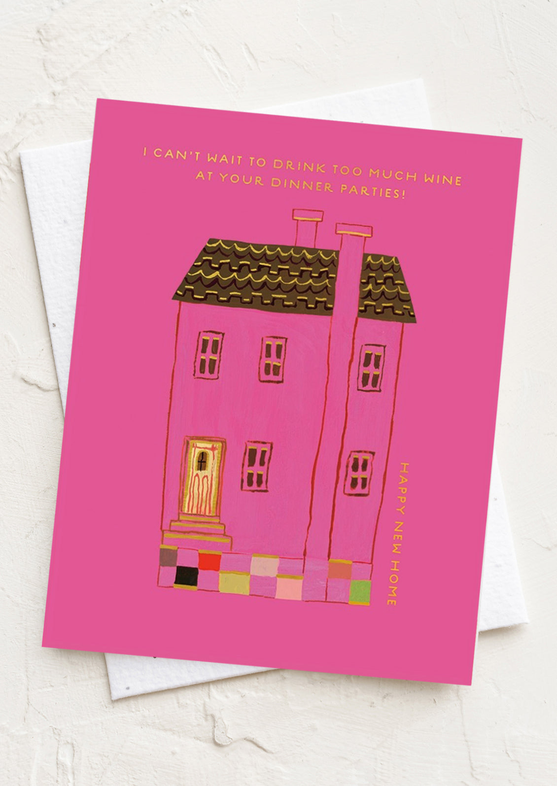 A pink card reading "I can't wait to have too much wine at your dinner parties - Happy new home!".