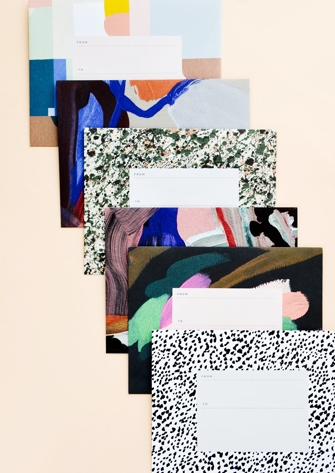 An array of abstract printed mailing envelopes in assorted designs